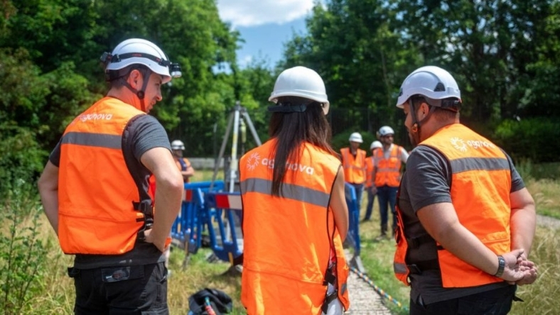 Utility workers in safety gear inspecting water pipeline site
