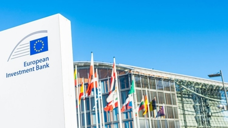 European Investment Bank sign outside office building with EU flags